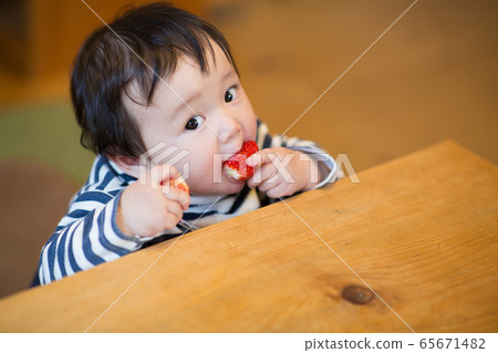 Infant eating snack Infant eating snack 65671482
