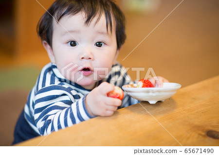 Infant eating snack Infant eating snack 65671490