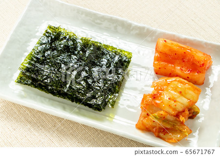 Assorted Korean style snacks. Korean seaweed, Kakuteki (radish kimchi), Chinese cabbage kimchi. 65671767