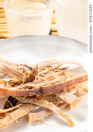 It's a hit. In the back of the photo is a glass sake bottle. Image of summer sake and cold sake snacks. 65672685