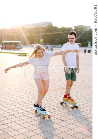 young blondhaired woman longboarding young blondhaired woman longboarding 65675391