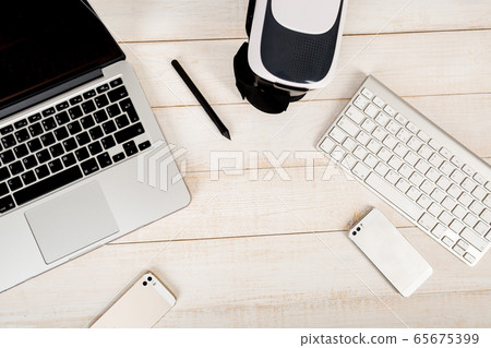 Set of modern gadgets arranged on a white wooden 65675399