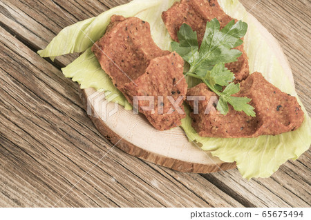 Turkish appetizer made of raw minced meat and 65675494