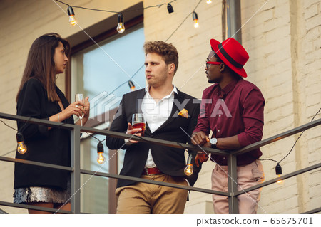 Multiethnic group of people celebrating, look happy, have corporate party at office or bar 65675701