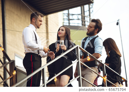 Group of young caucasian people celebrating, look happy, have corporate party at office or bar 65675704