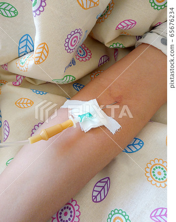 antibiotic medical dropper and needle inserted into a vein in the arm 65676234