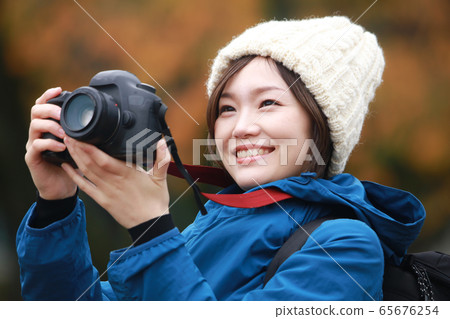 A woman taking a picture 65676254