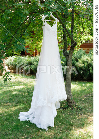 Vertical frame of white long lace bridal dress Vertical frame of white long lace bridal dress 65676569