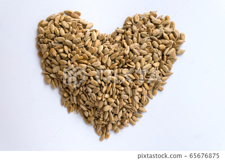 peeled sunflower seeds make a heart shape on white peeled sunflower seeds make a heart shape on white 65676875