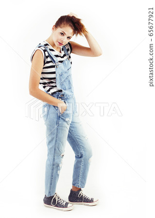 young pretty teenage hipster girl posing emotional happy smiling on white background, lifestyle people concept 65677921