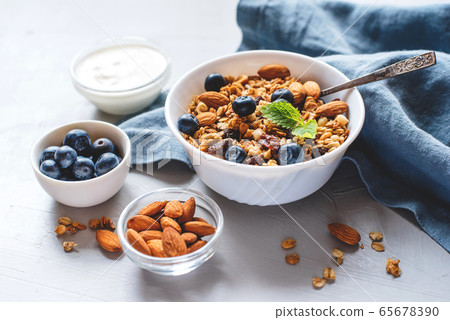 Baked granola with yogurt and blueberries. Baked granola with yogurt and blueberries. 65678390