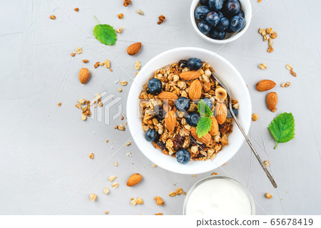 Baked granola with yogurt and blueberries. 65678419