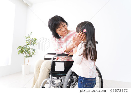 A girl and a girl in a wheelchair A girl and a girl in a wheelchair 65678572