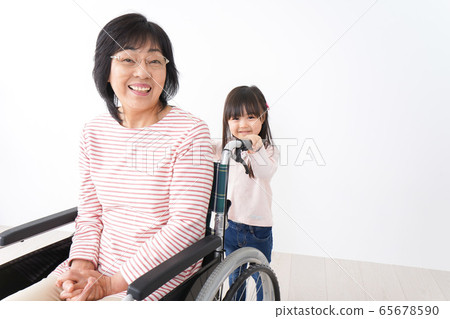 A girl and a girl in a wheelchair 65678590