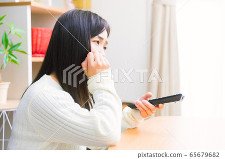 Woman watching TV emotional copy space Woman watching TV emotional copy space 65679682