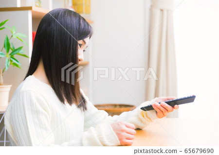 Woman watching TV Enjoying copy space Woman watching TV Enjoying copy space 65679690