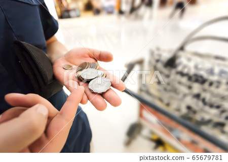 Hong Kong dollar coins in male hand at airport 65679781