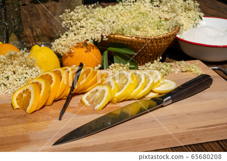 A cutting board with a vanilla pod, a sliced 65680208