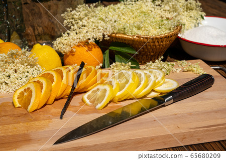A cutting board with a vanilla pod, a sliced 65680209