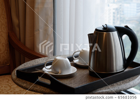 Kettle and tea cup in the living room 65681056
