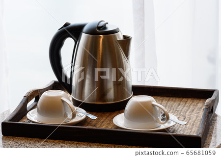 Kettle and tea cup in the living room 65681059