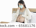 Young Asain woman coughing for effective caused of cold or influenza, wearing mask cover her face. 65681176