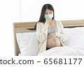 Young Asain woman coughing for effective caused of cold or influenza, wearing mask cover her face. 65681177