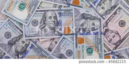 Many one hundred dollar bills are scattered on the table Many one hundred dollar bills are scattered on the table 65682215