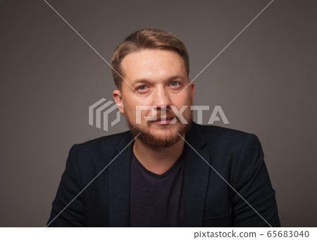 Handsome man over dark background looking at Handsome man over dark background looking at 65683040