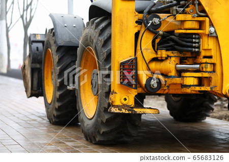 Excavator standing at pavement ready to work Excavator standing at pavement ready to work 65683126