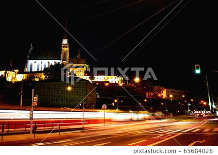 A traffic light on a city street at night A traffic light on a city street at night 65684028