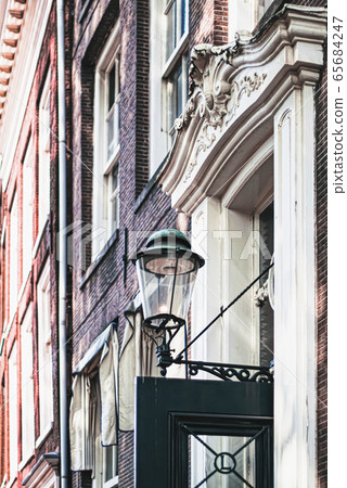 Architectural detail of a building on the main city center street of Amsterdam in Netherlands Architectural detail of a building on the main city center street of Amsterdam in Netherlands 65684247