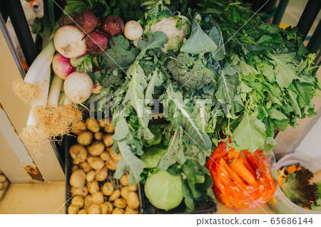 A stall with vegetables and fruits in the market 65686144