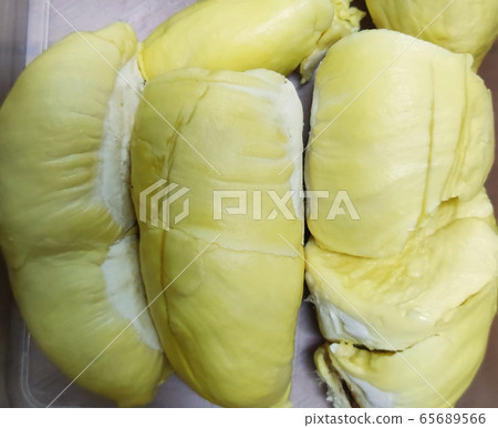 group of yellowish raped  Fresh durian on sack, king of fruit from Thailand, favorite souvenir at fresh market for tourism, food backgrounds 65689566