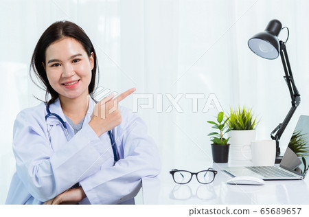 Asian female doctor working personal laptop 65689657