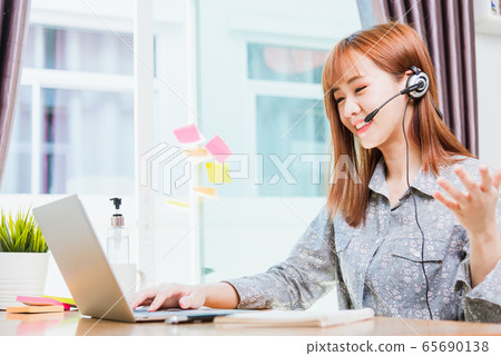 business woman wearing headphone call online business woman wearing headphone call online 65690138