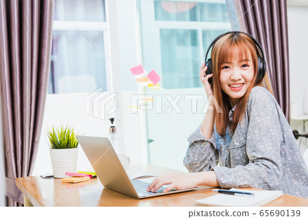 business woman wearing headphone call online business woman wearing headphone call online 65690139