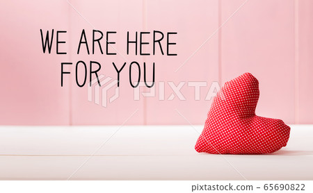 We are Here for You message with a red heart cushion 65690822