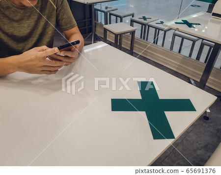 Restaurants in Thailand have measures to prevent the spread of COVID 19 virus by allowing to sit and eat only one table per person 65691376