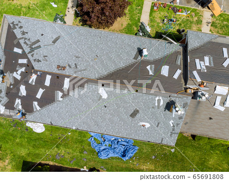 Roofer replace shingle that has been damaged and 65691808