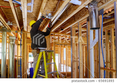 The electrician nailing to the ceiling lamp, The electrician nailing to the ceiling lamp, 65691893