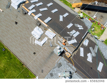 Roofer replace shingle that has been damaged and 65692048