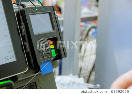 Close up of moment of payment by credit card into Close up of moment of payment by credit card into 65692069