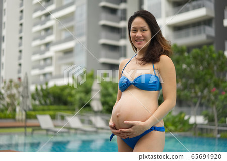 Asian Chinese Pregnant Woman Mother posing by the Asian Chinese Pregnant Woman Mother posing by the 65694920