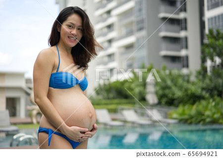 Asian Chinese Pregnant Woman Mother posing by the Asian Chinese Pregnant Woman Mother posing by the 65694921