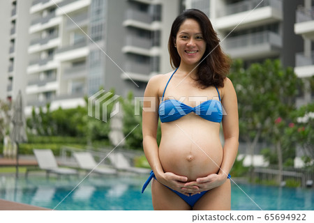 Asian Chinese Pregnant Woman Mother posing by the Asian Chinese Pregnant Woman Mother posing by the 65694922