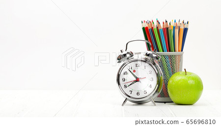 Office workplace with supplies and alarm clock Office workplace with supplies and alarm clock 65696810