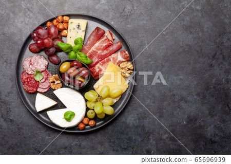 Cheese, meat, grapes and olives antipasto 65696939