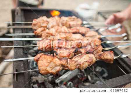 Kebabs on skewers over charcoal on the outside Kebabs on skewers over charcoal on the outside 65697482
