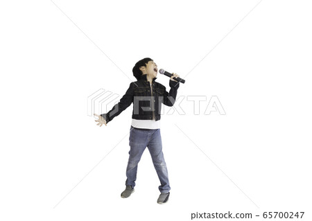 A cute young Asian elementary school student enjoying singing. An isolated image with white background. 65700247